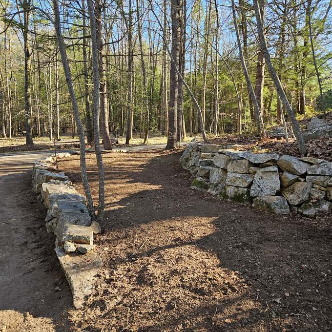 The same stone wall and driveway edge raked clean